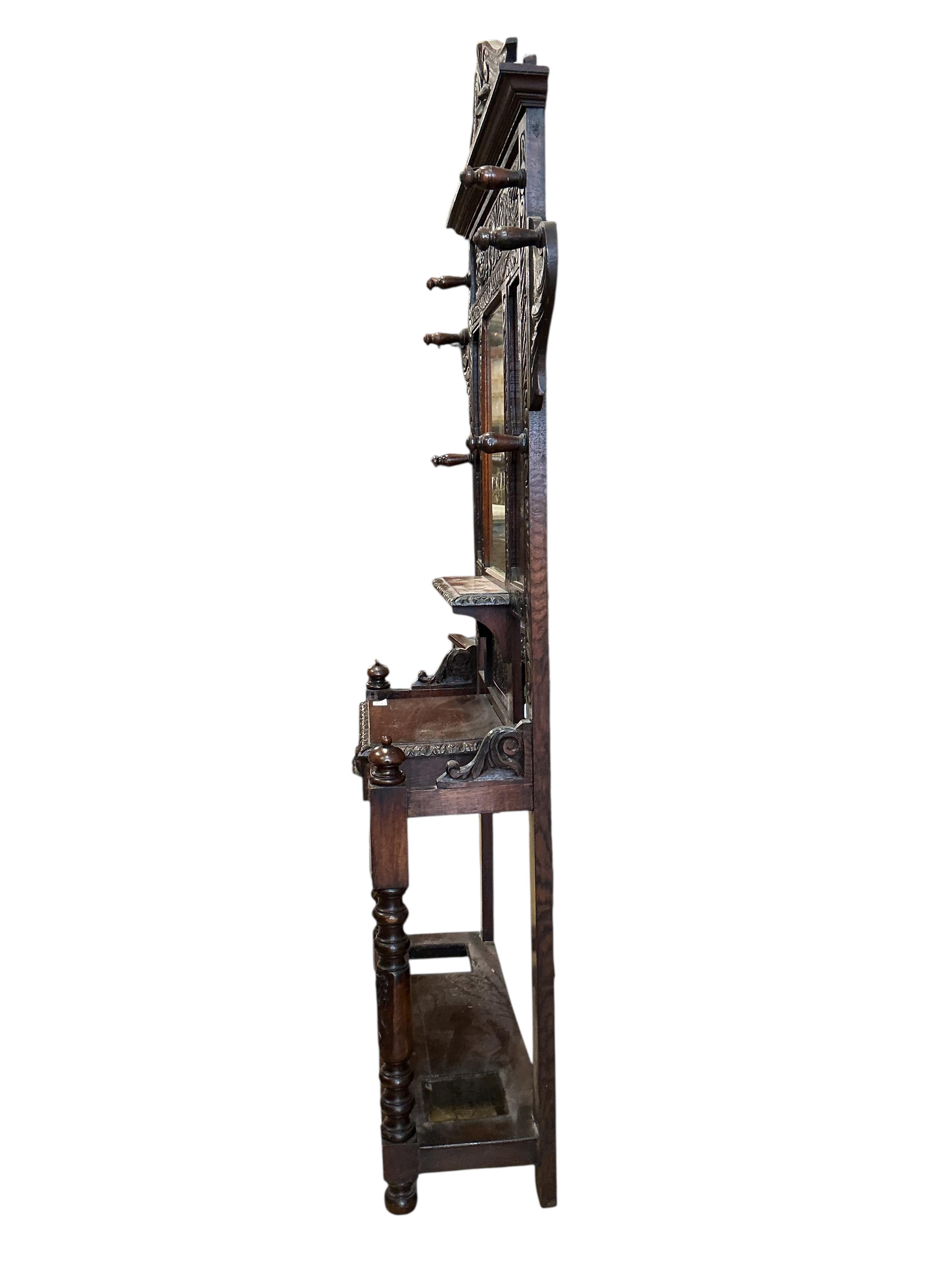 A late Victorian carved oak hall stand, width 120cm, depth 33cm, height 221cm